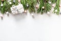 Christmas border with white gift, pink baubles and fir branches on white Royalty Free Stock Photo