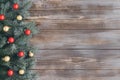 Christmas border on a wooden background. Fir branches and red gold baubles. Festive decorations. Happy new year. Space for text. Royalty Free Stock Photo