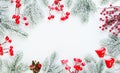 Christmas border. Xmas background composition with green fir branch, red holly berries and snow. Xmas flat lay top view Royalty Free Stock Photo