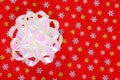 Christmas bow on red snowflake paper