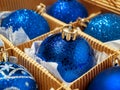 A Christmas box with blue Christmas balls and gifts, Christmas trinkets. preparing for the holiday Royalty Free Stock Photo