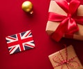 Christmas, boxing day and United Kingdom flag, traditional holiday gifts, presents on red background flat lay, wrapped Royalty Free Stock Photo