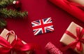 Christmas, boxing day and United Kingdom flag, traditional holiday gifts, presents on red background flat lay, wrapped Royalty Free Stock Photo