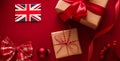 Christmas, boxing day and United Kingdom flag, traditional holiday gifts, presents on red background flat lay, wrapped Royalty Free Stock Photo