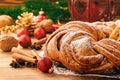 Christmas braided cinnamon roll cake on festive table.