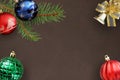 Christmas branch fir, blue, wavy red and green ribbed balloons, decorative bell on dark