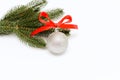 Christmas branch of pine tree and silver ball with red bow on white background. New years card Royalty Free Stock Photo