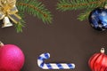 Christmas branches of spruce, stick, blue, pink and red balloon, decorative bell on dark background Royalty Free Stock Photo