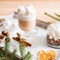 Christmas breakfast, pastry with winter spices and cappuccino, cinnamon and tangerine on a tray . There is a place for your inscri