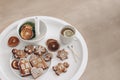 Christmas breakfast. Winter still life scene. Cup of tea, lemon and gingerbread cookies. White round coffee table