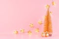 Christmas bright and gentle background with glitter gold decorations, Christmas tree and glowing stars lights on elegant pastel. Royalty Free Stock Photo