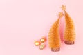 Christmas bright and gentle background with glitter gold decorations, Christmas trees, stars on elegant pastel pink background. Royalty Free Stock Photo