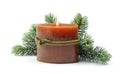 Christmas burning candle, snowy pine branches on a white background. Christmas or Winter holiday concept. Isolated