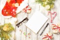 Christmas and Business Items with Copy Space cropped Santa Cap Notepad Pen Glasses and decorated Gift Box and fir tree