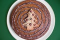 Christmas cake with chocolate spiral and candy sprinkles. cookie in shape of a tree