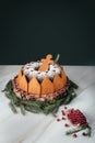 Christmas cake with funny gingerbread men on marble table with black background for your copy. Christmas pomegranat cake