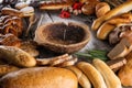 Christmas cake, rolls and breads on wooden table with wooden bowl, background for bakery or market Royalty Free Stock Photo