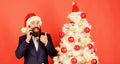 Christmas call. Create santa call this christmas. Man bearded wear suit and santa hat hold phone. Manager congratulate