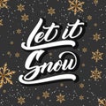 Christmas calligraphy. Hand drawn lettering Let It Snow on dark background with golden snowflakes. Brush calligraphy Royalty Free Stock Photo