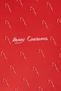 Christmas candies canes on red background. Flat lay and top view Royalty Free Stock Photo