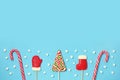 Christmas candies and mini marshmallows on blue background Royalty Free Stock Photo