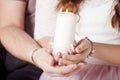 Christmas candle. Christmas decor. Hands of man and woman holding burning  candle. Happy family concept Royalty Free Stock Photo