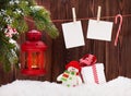 Christmas candle lantern, gift box and photos Royalty Free Stock Photo