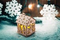 Christmas candle lantern and Christmas tree branches, snow, snowflake and decorations on bokeh background blurred lights Royalty Free Stock Photo