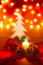 Christmas candle and ornaments over dark background with lights Royalty Free Stock Photo