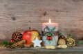 Christmas candle with star cookie, red apple, nuts and spices Royalty Free Stock Photo