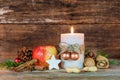 Christmas candle with star cookie, red apple, nuts and spices Royalty Free Stock Photo