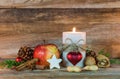 Christmas candle with star cookie, red apple, nuts and spices Royalty Free Stock Photo