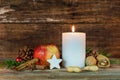 Christmas candle with star cookie, red apple, nuts and spices Royalty Free Stock Photo