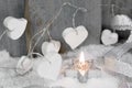 Christmas candle in white with hearts, wood and snow for decoration Royalty Free Stock Photo