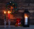 Christmas candles and decorations with toy Santa Claus in dark interior.Cristmas concept. New Year concept.