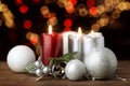 Christmas candles and ornaments over blurred festive lights Royalty Free Stock Photo