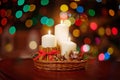 Christmas candles and ornaments over dark background  of de-focused lights Royalty Free Stock Photo
