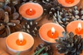 Christmas candles and pine cines selective focus