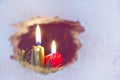 Christmas candles on a snowy window Royalty Free Stock Photo