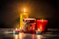 Christmas candles on wooden table. Dim light. Royalty Free Stock Photo