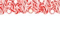 Christmas candy border with peppermints and candy canes over white