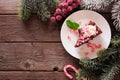 Christmas candy cane chocolate cheesecake, top view corner border over a dark wood background Royalty Free Stock Photo