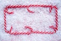 Christmas candy cane frame on snow Royalty Free Stock Photo