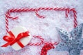 Christmas candy cane frame on snow Royalty Free Stock Photo