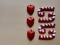 Christmas candy cane and hearts at studio above view over a brwon cream neutral background isolate