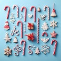 Christmas candy cane lied evenly in row on blue background. Flat lay and top view Royalty Free Stock Photo