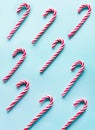 Christmas candy cane lied evenly in row on blue. Flat lay and top view Royalty Free Stock Photo