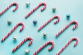 Christmas candy cane lied evenly in row on blue. Flat lay and top view Royalty Free Stock Photo