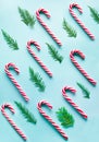 Christmas candy cane lied evenly in row on blue. Flat lay and top view Royalty Free Stock Photo