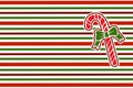 Christmas candy cane on a striped wrapping paper background. Red and green stripes. Christmas geometric pattern. Royalty Free Stock Photo